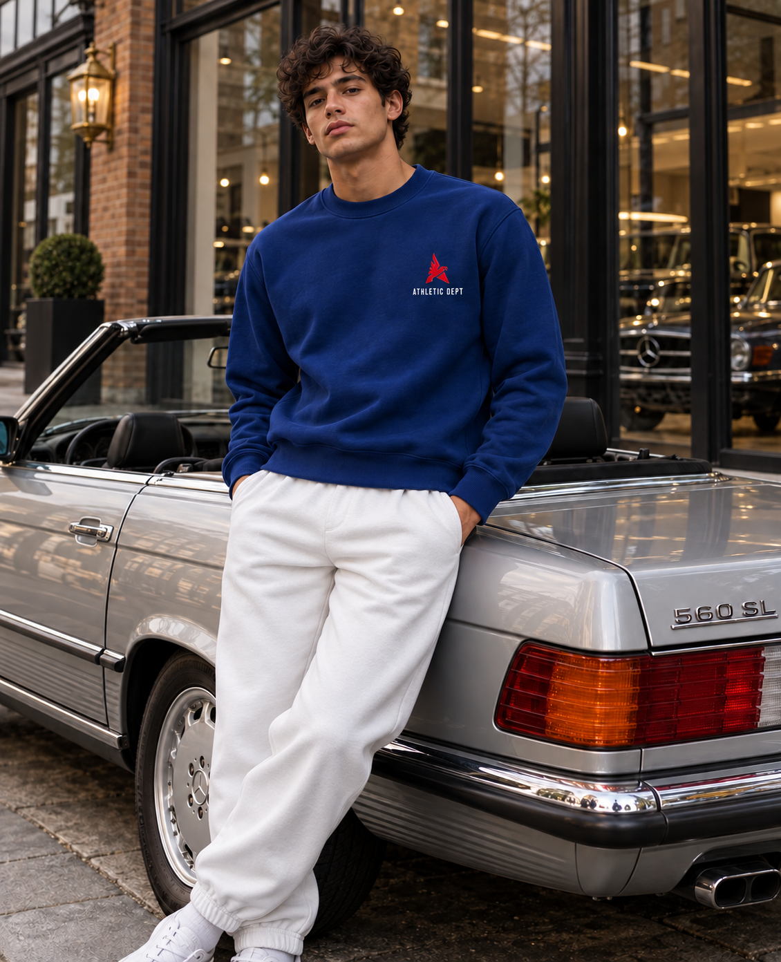 Royal blue Drafted Brand sweatshirt with white and red graphics and white joggers, front view