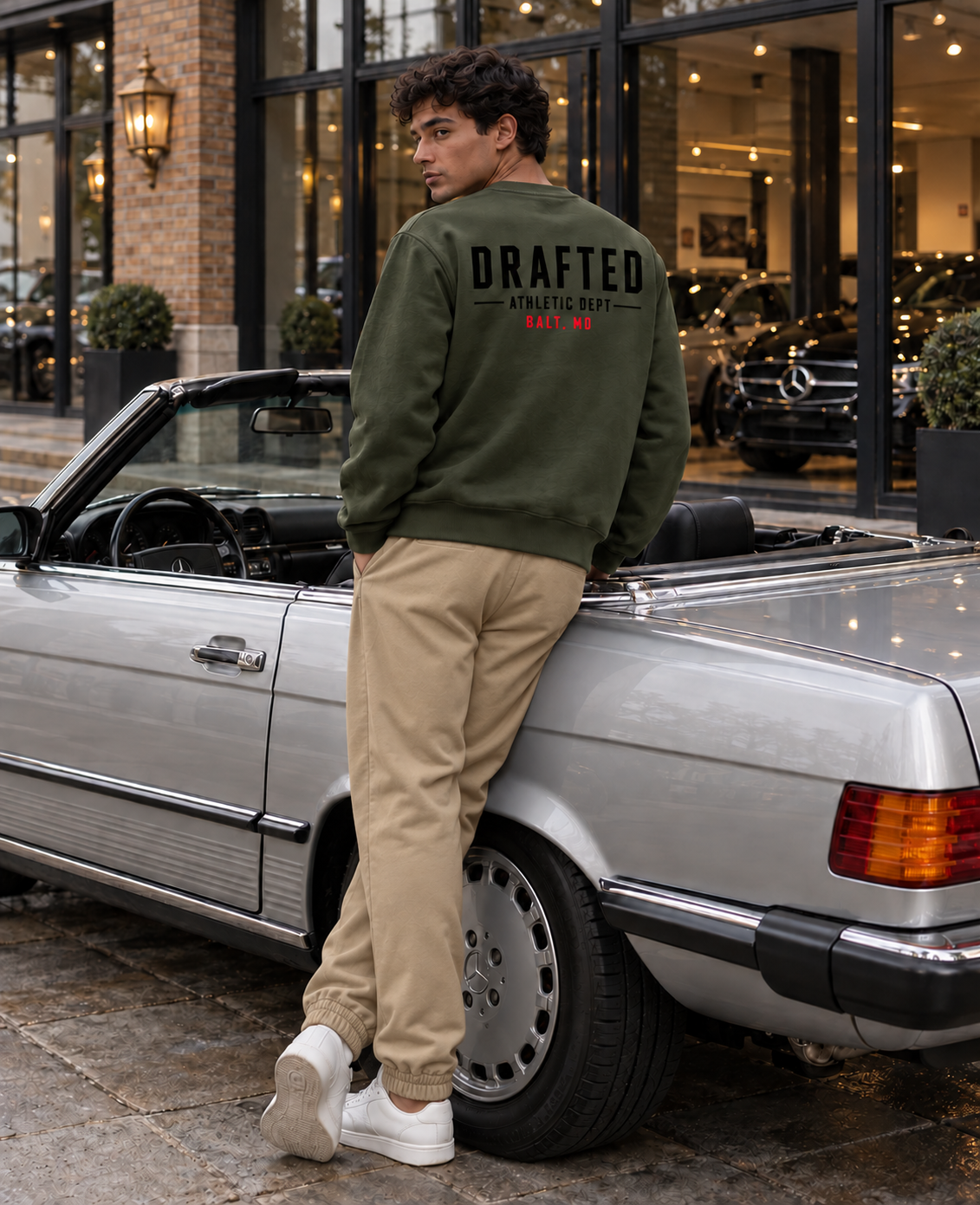 Army green Drafted Brand sweatshirt with tan khaki joggers, back view at London Mercedes dealership