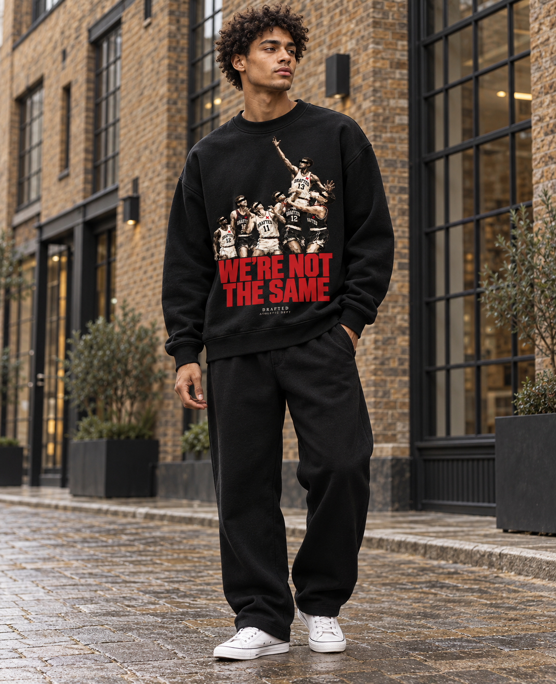 Athlete wearing the black Drafted Contested sweatshirt on an East London street